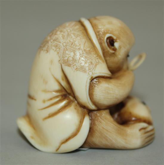 A Japanese ivory netsuke of a monkey viewing an insect through a magnifying glass, signed Masatami, Edo period, 3.6cm